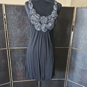 Chic Black Sleeveless Blouse with Rosette Accents